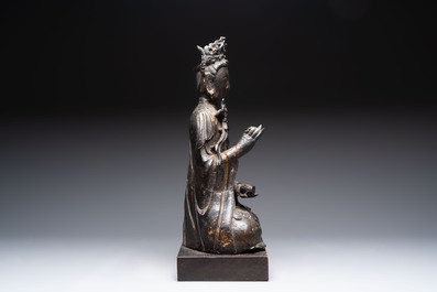 A large Chinese bronze Bodhisattva on wooden stand, Ming