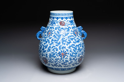 A Chinese blue, white and copper-red 'hu' vase with lotus scrolls, Qianlong mark, 19th C.