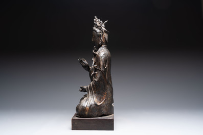 A large Chinese bronze Bodhisattva on wooden stand, Ming