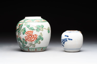 A Chinese famille verte covered vase, a pair of blue and white jars on wooden stands and two jars, 19th C.