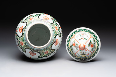 A Chinese famille verte covered vase, a pair of blue and white jars on wooden stands and two jars, 19th C.