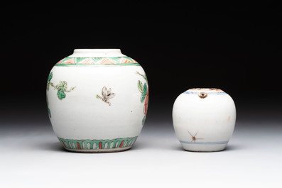 A Chinese famille verte covered vase, a pair of blue and white jars on wooden stands and two jars, 19th C.