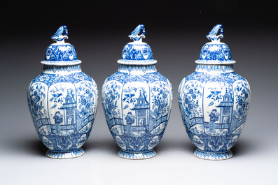 A blue and white Dutch Delft garniture of five vases and covers, 19th C.