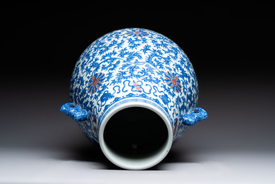 A Chinese blue, white and copper-red 'hu' vase with lotus scrolls, Qianlong mark, 19th C.