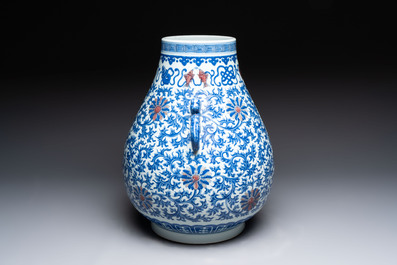 A Chinese blue, white and copper-red 'hu' vase with lotus scrolls, Qianlong mark, 19th C.