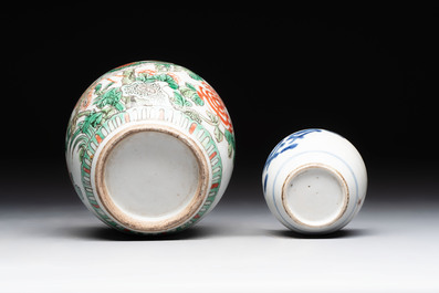 A Chinese famille verte covered vase, a pair of blue and white jars on wooden stands and two jars, 19th C.