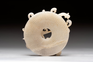 A Chinese carved white and russet jade bi-disc with chilong design, 19/20th C.