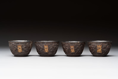 Four Chinese carved and silver-lined coconut cups, 19/20th C.