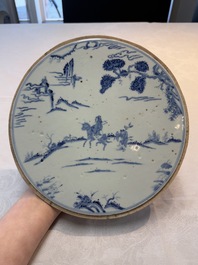 A Chinese blue and white circular plaque with two figures in a landscape, 19/20th C.