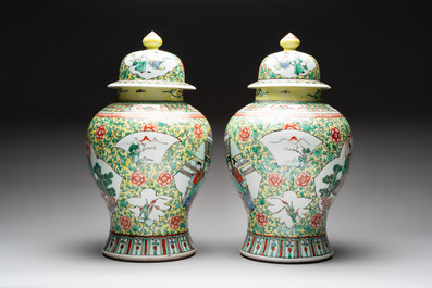 A pair of Chinese famille verte yellow-ground 'Xi Xiang Ji' vases and covers, 19th C.