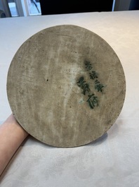 A Chinese blue and white circular plaque with two figures in a landscape, 19/20th C.