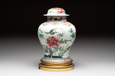 Three Chinese famille rose covered vases, one on a gilt bronze stand, and a covered jar, 19/20th C.
