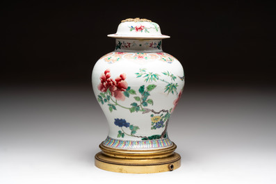 Three Chinese famille rose covered vases, one on a gilt bronze stand, and a covered jar, 19/20th C.