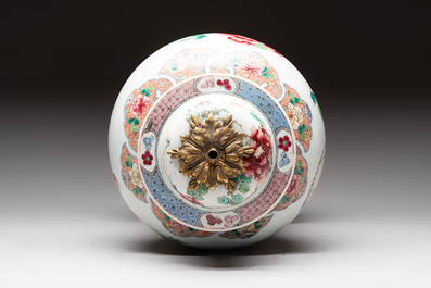 Three Chinese famille rose covered vases, one on a gilt bronze stand, and a covered jar, 19/20th C.