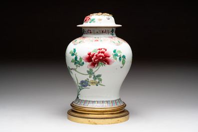Three Chinese famille rose covered vases, one on a gilt bronze stand, and a covered jar, 19/20th C.