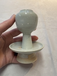 A pair of white-glazed oil lamps, a Longquan celadon vase and Yaozhou celadon box and cover, Ming/Qing