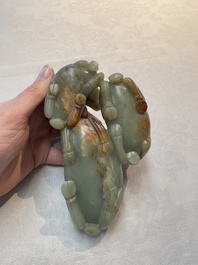 A Chinese celadon jade group of three goats on wooden stand, 19/20th C.