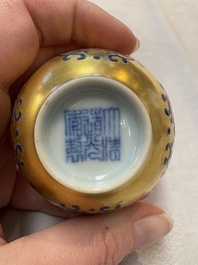 A pair of Chinese gilt-and blue-enamelled 'shou 壽' cups, Daoguang mark and possibly of the period