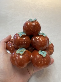 A pair of Chinese polychrome 'persimmons' groups on wooden stands, 19th C.