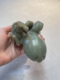 A Chinese celadon jade group of three goats on wooden stand, 19/20th C.