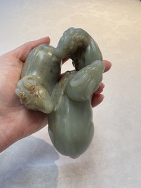 A Chinese celadon jade group of three goats on wooden stand, 19/20th C.