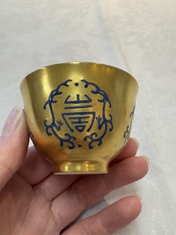 A pair of Chinese gilt-and blue-enamelled 'shou 壽' cups, Daoguang mark and possibly of the period