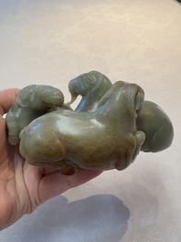 A Chinese celadon jade group of three goats on wooden stand, 19/20th C.