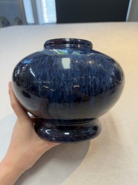 A Chinese flamb&eacute;-glazed vase on wooden stand, 19th C.