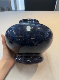 A Chinese flamb&eacute;-glazed vase on wooden stand, 19th C.