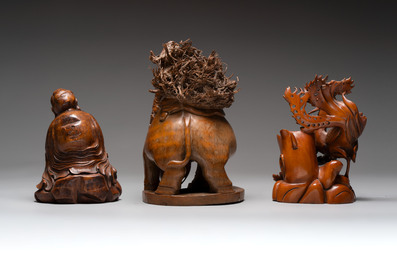Three Chinese carved bamboo figures and a boxwood carving of a phoenix, 20th C.