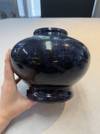 A Chinese flamb&eacute;-glazed vase on wooden stand, 19th C.