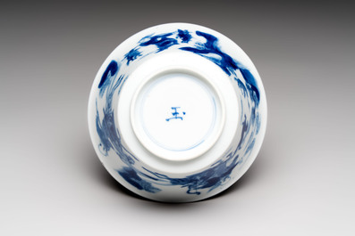 A Chinese blue and white 'Mongolian hunting' cup and saucer, jade mark, Kangxi