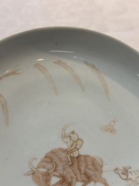 A Chinese iron-red-decorated 'boy and buffalo' cup and saucer and a famille rose 'Xi Xiang Ji' cup and saucer, Qianlong