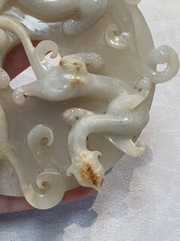 A Chinese carved white and russet jade bi-disc with chilong design, 19/20th C.
