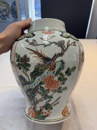 A Chinese famille verte covered vase, a pair of blue and white jars on wooden stands and two jars, 19th C.
