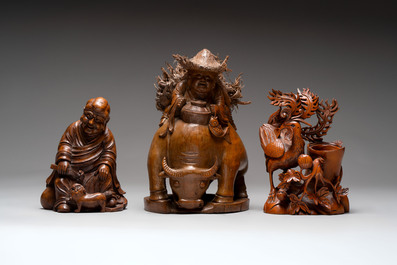 Three Chinese carved bamboo figures and a boxwood carving of a phoenix, 20th C.