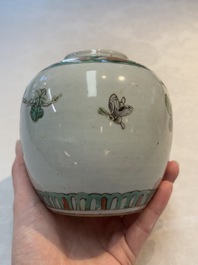 A Chinese famille verte covered vase, a pair of blue and white jars on wooden stands and two jars, 19th C.