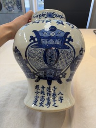 A Chinese blue and white vase and cover with calligraphy and antiquities, 19th C.