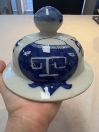 A Chinese blue and white vase and cover with calligraphy and antiquities, 19th C.