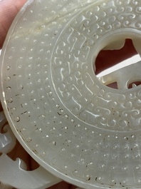 A Chinese carved white and russet jade bi-disc with chilong design, 19/20th C.