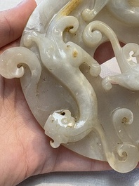 A Chinese carved white and russet jade bi-disc with chilong design, 19/20th C.