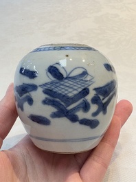 A Chinese famille verte covered vase, a pair of blue and white jars on wooden stands and two jars, 19th C.