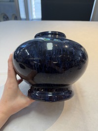 A Chinese flamb&eacute;-glazed vase on wooden stand, 19th C.