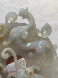 A Chinese carved white and russet jade bi-disc with chilong design, 19/20th C.