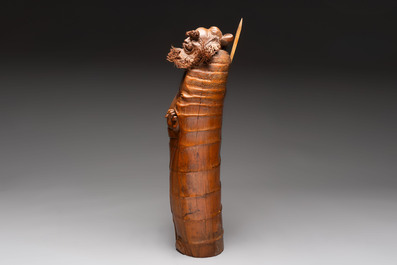 Three Chinese carved bamboo figures and a boxwood carving of a phoenix, 20th C.