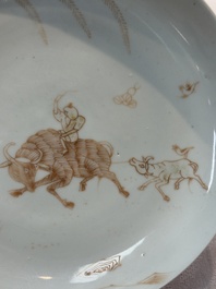 A Chinese iron-red-decorated 'boy and buffalo' cup and saucer and a famille rose 'Xi Xiang Ji' cup and saucer, Qianlong