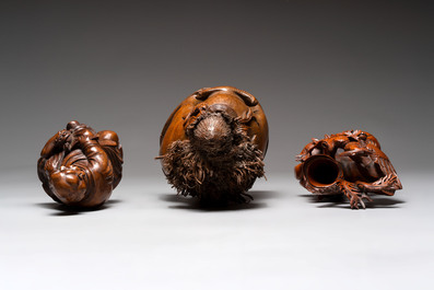 Three Chinese carved bamboo figures and a boxwood carving of a phoenix, 20th C.