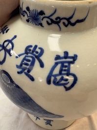 A Chinese blue and white vase and cover with calligraphy and antiquities, 19th C.