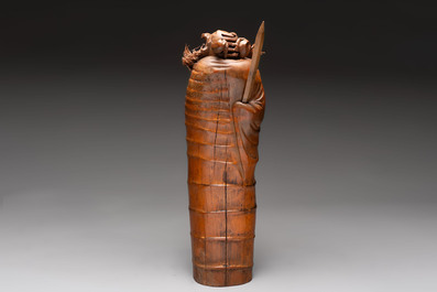 Three Chinese carved bamboo figures and a boxwood carving of a phoenix, 20th C.