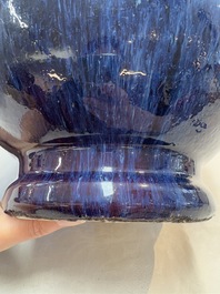 A Chinese flamb&eacute;-glazed vase on wooden stand, 19th C.